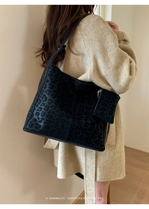 Detail of leopard print tote bag with matching coin purse on a wool coat outfit