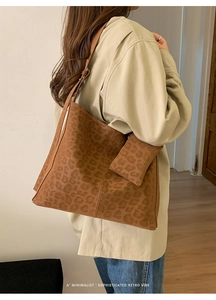 Detailed view of leopard print suede tote bag with matching mini pouch and strap
