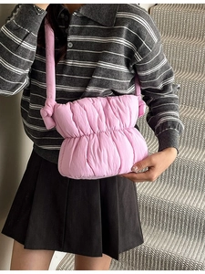Pink quilted cloud crossbody bag with soft padded strap and pleated puffy nylon texture