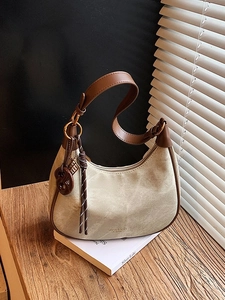 Minimalist beige hobo shoulder bag with brown leather trim and metal ring hardware