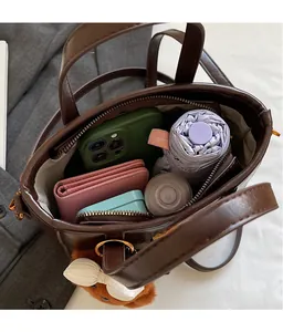 Top view of spacious brown leather tote bag showing internal storage for daily essentials