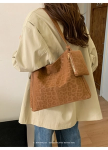 Detail of leopard print tote bag with detachable small zipper pouch and matte texture