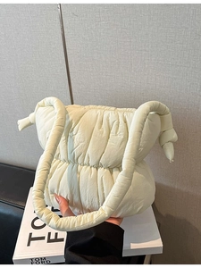 Minimalist beige quilted puffer cloud bag with knot handle for women's autumn winter style