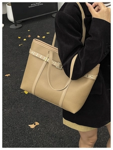 Fashionable khaki pebble leather tote bag shown in an autumn street style setting