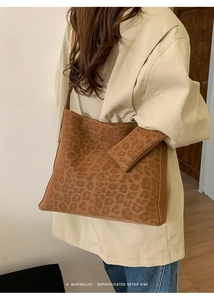Close-up of brown leopard print suede tote bag with matching accessory pouch
