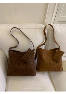 Detail of leopard print tote bags in dark coffee and light brown with matching pouches
