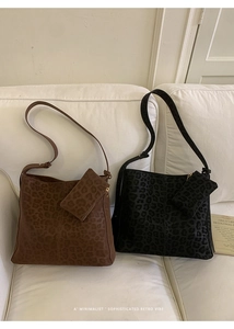 Detail of leopard print faux suede shoulder bags with matching small zipper pouches