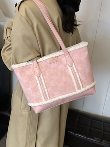 Pink quilted tote bag with white fleece trim worn by model in a stylish trench coat