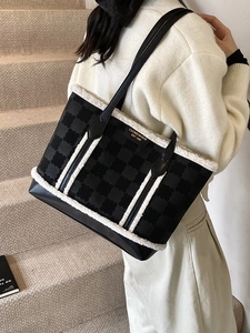 Women's black floral embossed tote bag with white faux fur trim and gold emblem