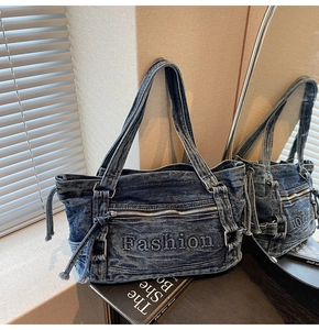 Detailed macro view of the Fashion embroidery on a blue washed denim tote bag
