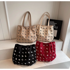 Four minimalist canvas tote bags with digital prints in khaki, cream, black, and red