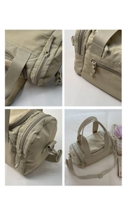 Macro detail of the smooth zipper, fine stitching and durable nylon fabric of the tote bag