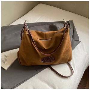 Detailed view of caramel suede large capacity handbag with contrast leather trim