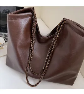 Detailed view of the dark brown PU leather tote bag featuring a metal chain strap