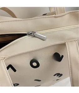 Detailed close-up of beige canvas texture with silver metal zipper and black numeric print