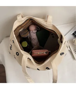Spacious interior of beige canvas tote bag showing storage capacity for daily essentials