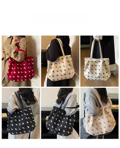 Detailed view of large printed canvas tote bags shown in five colors on models