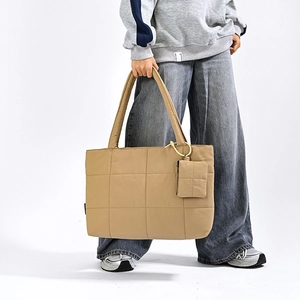 Detail of khaki quilted tote bag with matching small coin purse for travel use