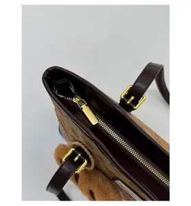 Close-up of golden zipper and brown suede texture on vintage retro tote bag