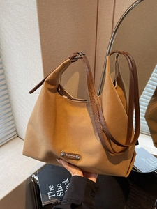 Classic camel canvas hobo tote bag with brown leather straps for elegant commuting
