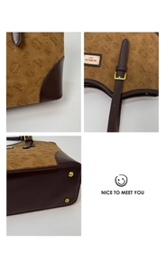 Close-up of retro brown tote bag featuring embossed cat patterns and gold metal feet