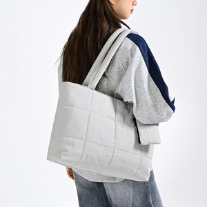 Light grey quilted tote bag with a minimalist design and large capacity for daily use