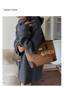 Detail view of khaki tote bag side profile featuring Bread Cat print and leather straps