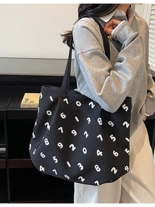 Minimalist black canvas tote bag featuring white number prints for casual commute fashion