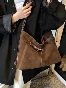 Retro large brown suede tote bag for women worn over shoulder with minimalist leather straps