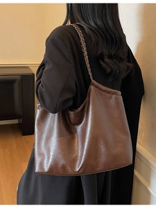 Retro deep brown tote bag with vintage texture and stylish metal chain shoulder strap