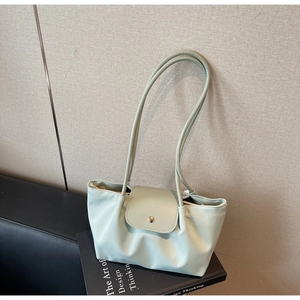 Detailed view of mint green soft leather tote bag with flap and metal buckle detail