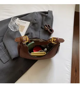 Interior view of the dark brown hobo bag showing capacity for phone and cosmetics