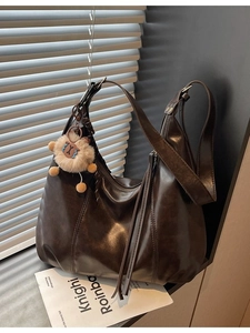 Vintage dark brown large hobo shoulder bag with plush lion keychain and tassel detail