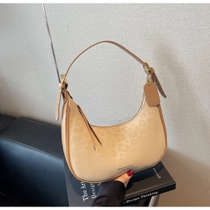 Detail of leopard print crescent bag with tassel zipper and adjustable strap