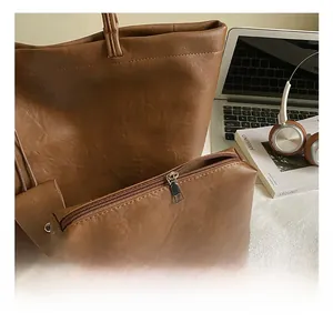 Brown leather tote bag set and small makeup pouch shown with lifestyle accessories