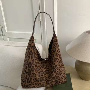 Detail of leopard print tote bag featuring high-capacity interior and magnetic snap closure