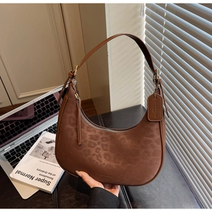 Leopard print crescent bag featuring contrast suede textures and leather strap detail