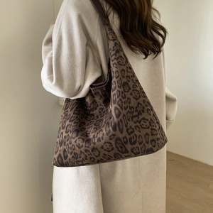 Rear view of a model wearing a large leopard print tote bag for casual daily commuting