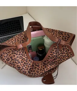 Spacious leopard print tote bag interior showing capacity for tablets and cosmetics