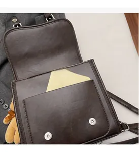 Detail of durable inner pocket on vintage brown suede backpack with silver magnetic closure