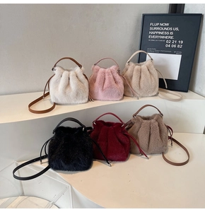 Detail view of plush faux fur bucket bags in six colors with leather drawstring straps