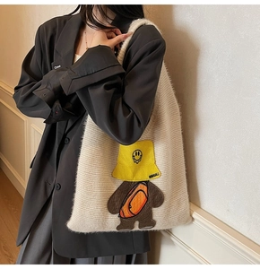 Close-up of beige plush tote bag with a 3D cartoon bear patch and embroidery detail