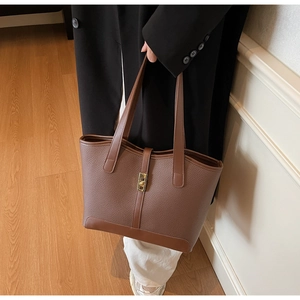 Vue détaillée du sac cabas marron foncé en cuir grainé avec fermoir doré métallisé