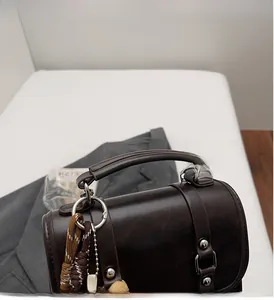 Close-up of the durable handle and silver metal rings on a vintage suede backpack