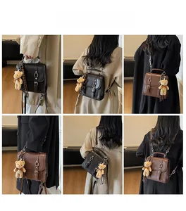 Three-way carry demonstration of vintage brown PU leather backpack with teddy bear charm