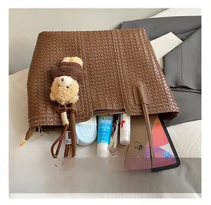 Top view of large woven tote bag showing spacious interior with tablet and daily items