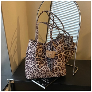 Close-up of leopard print canvas tote bag with a cute plush bear charm for daily use