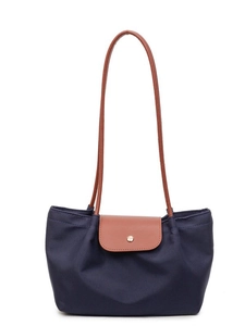 Large navy blue nylon tote bag with brown leather handles in a classic folding design