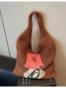 Brown fuzzy plush tote bag with decorative patches and soft knit texture for women