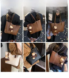 Detailed street style shots of a large woven tote bag in brown, cream, and black colors